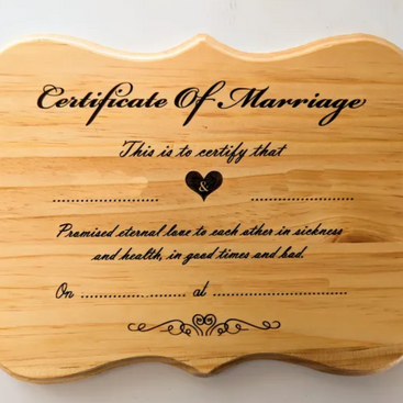 Wooden plaque with 'Certificate of Marriage' text on a white background